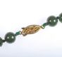 STRING OF JADE BEADS WITH PIERCED 9 CT GOLD CLASP at Ross's Online Art Auctions