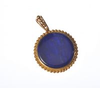 YELLOW METAL CIRCULAR PENDANT WITH A BLUE LAPIS PANEL at Ross's Online Art Auctions