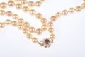 STRING OF CULTURED PEARLS WITH A 9 CARAT AMETHYST & SEED PEARL CATCH at Ross's Online Art Auctions