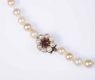 STRING OF CULTURED PEARLS WITH 9CT GOLD & GARNET CLASP at Ross's Online Art Auctions