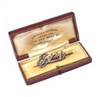 WHITE GOLD BAR BROOCH WITH DIAMOND ENCRUSTED LETTERS at Ross's Online Art Auctions