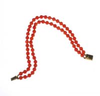 DOUBLE STRING OF RED CORAL BEAD BRACELET WITH A 9 CT GOLD CLASP at Ross's Online Art Auctions