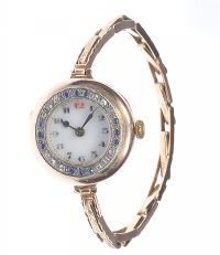 LADY'S 9 CT ROSE GOLD WRIST WATCH WITH SAPPHIRE & DIAMOND BEZEL & EXPANDING STRAP at Ross's Online Art Auctions