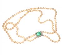 DOUBLE STRING OF SEAWATER PEARLS WITH AN ART DECO STYLE EMERALD & DIAMOND CLASP at Ross's Online Art Auctions