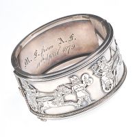 HEAVY SILVER VICTORIAN BANGLE WITH HIEROGLYPHICS IN RELIEF at Ross's Online Art Auctions