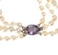 EDWARDIAN GRADUATED TRIPLE STRING OF CULTURED PEARLS WITH AMETHYST CLASP at Ross's Online Art Auctions