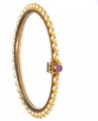 GOLD PLATE AND CULTURED PEARL BANGLE WITH RUBY CLASP at Ross's Online Art Auctions