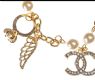 METAL AND FAUX PEARL CHARM BRACELET IN THE STYLE OF CHANEL at Ross's Online Art Auctions