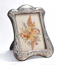STERLING SILVER PHOTO FRAME IN A DAFFODIL DESIGN WITH PRESSED FLOWERS at Ross's Online Art Auctions