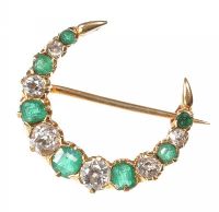 18CT GOLD EMERALD AND DIAMOND MINIATURE CRESCENT BROOCH at Ross's Online Art Auctions