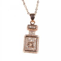 ROSE GOLD-COLOURED METAL AND CUBIC ZIRCONIA PERFUME BOTTLE PENDANT AND CHAIN IN THE STYLE OF CHANEL at Ross's Online Art Auctions