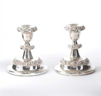 PAIR OF SILVER PLATED EMBOSSED DWARF CANDLESTICKS at Ross's Online Art Auctions