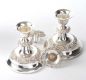 PAIR OF SILVER PLATED EMBOSSED DWARF CANDLESTICKS at Ross's Online Art Auctions