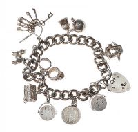 HEAVY STERLING SILVER CHARM BRACELET WITH TEN CHARMS at Ross's Online Art Auctions