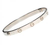 SILVER SLAVE BANGLE IN THE STYLE OF CARTIER at Ross's Online Art Auctions