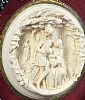 A VICTORIAN CIRCULAR CARVED BONE PICTURE OF A FAMILY GROUP IN MEDIEVAL DRESS IN A LANDSCAPE at Ross's Online Art Auctions
