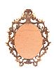 A VICTORIAN FLORENTINE CARVED GILTWOOD OVAL MIRROR at Ross's Online Art Auctions
