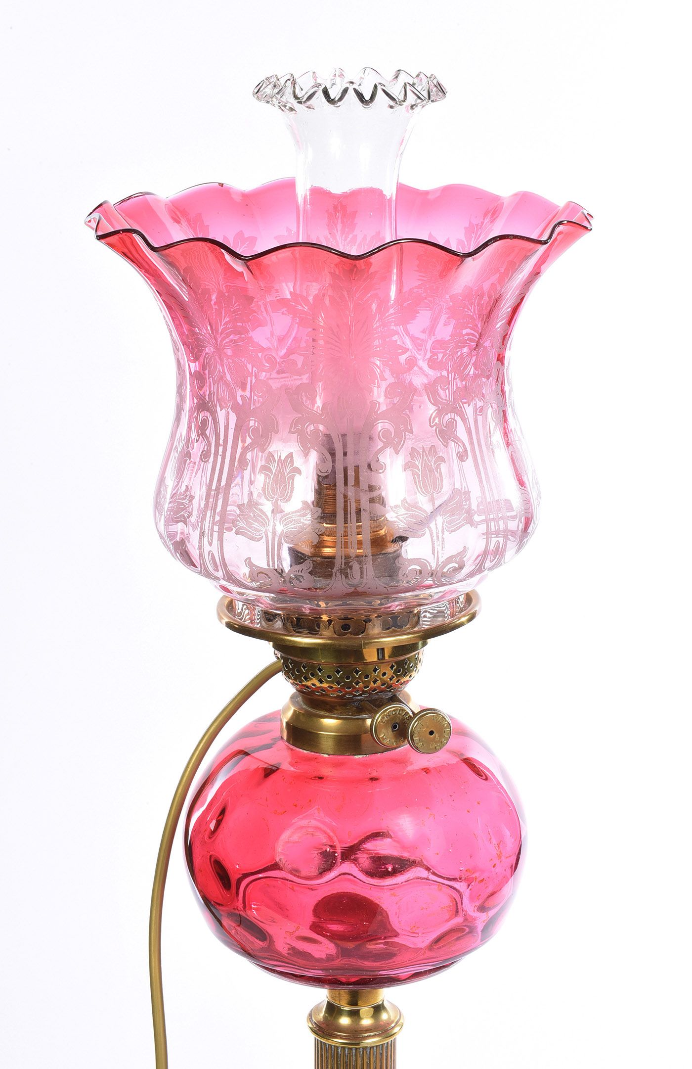 A VICTORIAN BRASS OIL LAMP WITH RUBY GLASS SHADE at Ross's Online Art Auctions